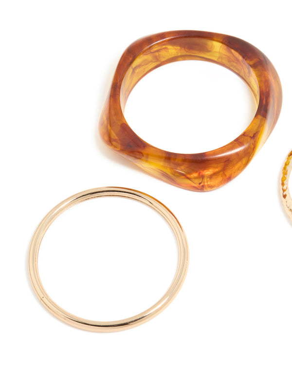 Crafted from gold and brown organic acrylic with orange tones bangle pack close up view