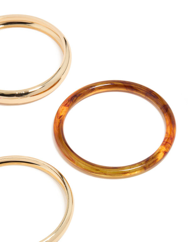 Featuring gold and mixed acrylic bangle 4-pack with hot pink band close up view