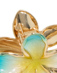 Crafted from floral enamel, this frangipani flower claw clip in turquoise, yellow, and gold detail view - link has visual effect only
