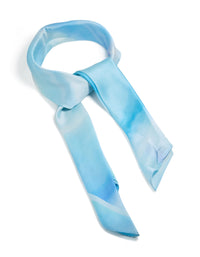 Showcasing a fabric scarf with tie-dye print in striped pattern and sky blue, powder blue, light blue, royal blue tones side view - link has visual effect only