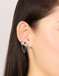Featuring silver blue cubic zirconia chain flower and huggie earrings 3-pack with floral accents on ear view - link has visual effect only