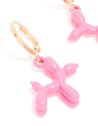 Crafted with animal design these pink balloon dog huggie earrings in gold close up view - link has visual effect only