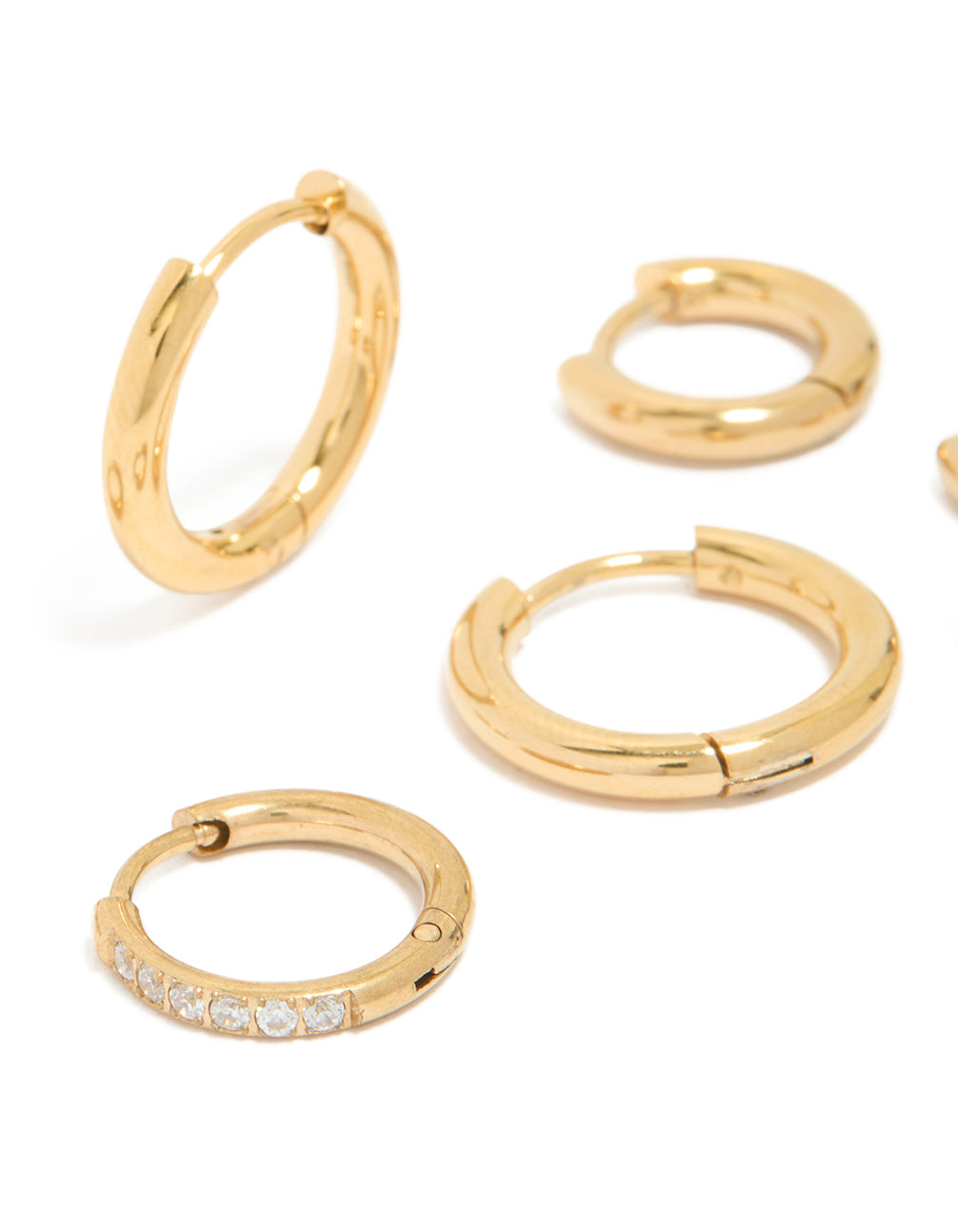 Presenting waterproof gold plated stainless steel cubic zirconia essential stacking huggie earrings in a 3-pack with crystal accents and closure close up view