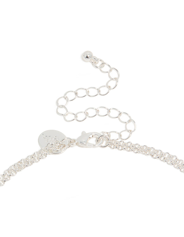 Presenting a silver plated layered necklace with cubic zirconia cross pendant clasp detail view