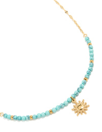 Showcasing a waterproof gold plated stainless steel turquoise semi precious stone sunburst pendant necklace with beads, celestial in gold close up view - link has visual effect only
