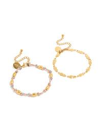 Showcasing waterproof bracelets in a 2-pack featuring ocean details, crafted from stainless steel, one with beads on pink and blue cord and one in gold plated finish front view - link has visual effect only