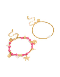 Showcasing waterproof gold plated stainless steel cord bracelets in a 2-pack featuring ocean charms with beads, rose quartz and freshwater pearl details in pink and white front view - link has visual effect only