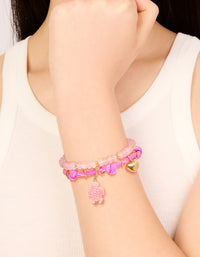 Showcasing waterproof gold plated stainless steel semi precious stone and sea cord bracelets in a 2-pack with beads, heart and ocean charm, rose quartz accents on wrist view - link has visual effect only