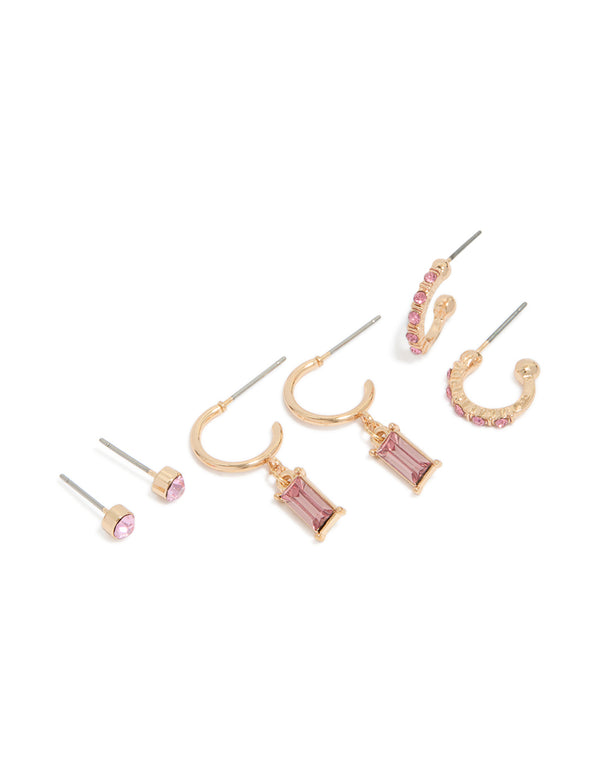 Featuring gold hoop and stud earrings in a 3-pack with light pink diamante accents front view