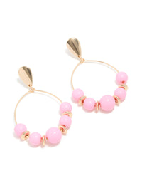 Statement drop earrings in gold featuring round pink beaded hoops front view - link has visual effect only