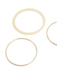 Featuring simple acrylic bangle in a 3-pack with gold and beige tones close up view - link has visual effect only
