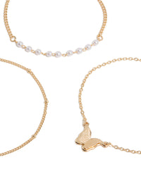 Showcasing gold butterfly charm and pearl bracelets in a 3-pack close up view - link has visual effect only