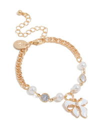 Crafted from gold with bow charm and pearl features in a statement bracelet front view - link has visual effect only