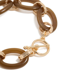 Highlighting a brown acrylic bracelet with gold accents, designed with detailed T-bar closure view - link has visual effect only