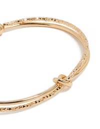 Featuring a gold textured and smooth knotted wrist cuff bangle close up view - link has visual effect only