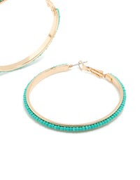 Designed with large thin aqua beaded hoop earrings in turquoise and gold post detail view - link has visual effect only