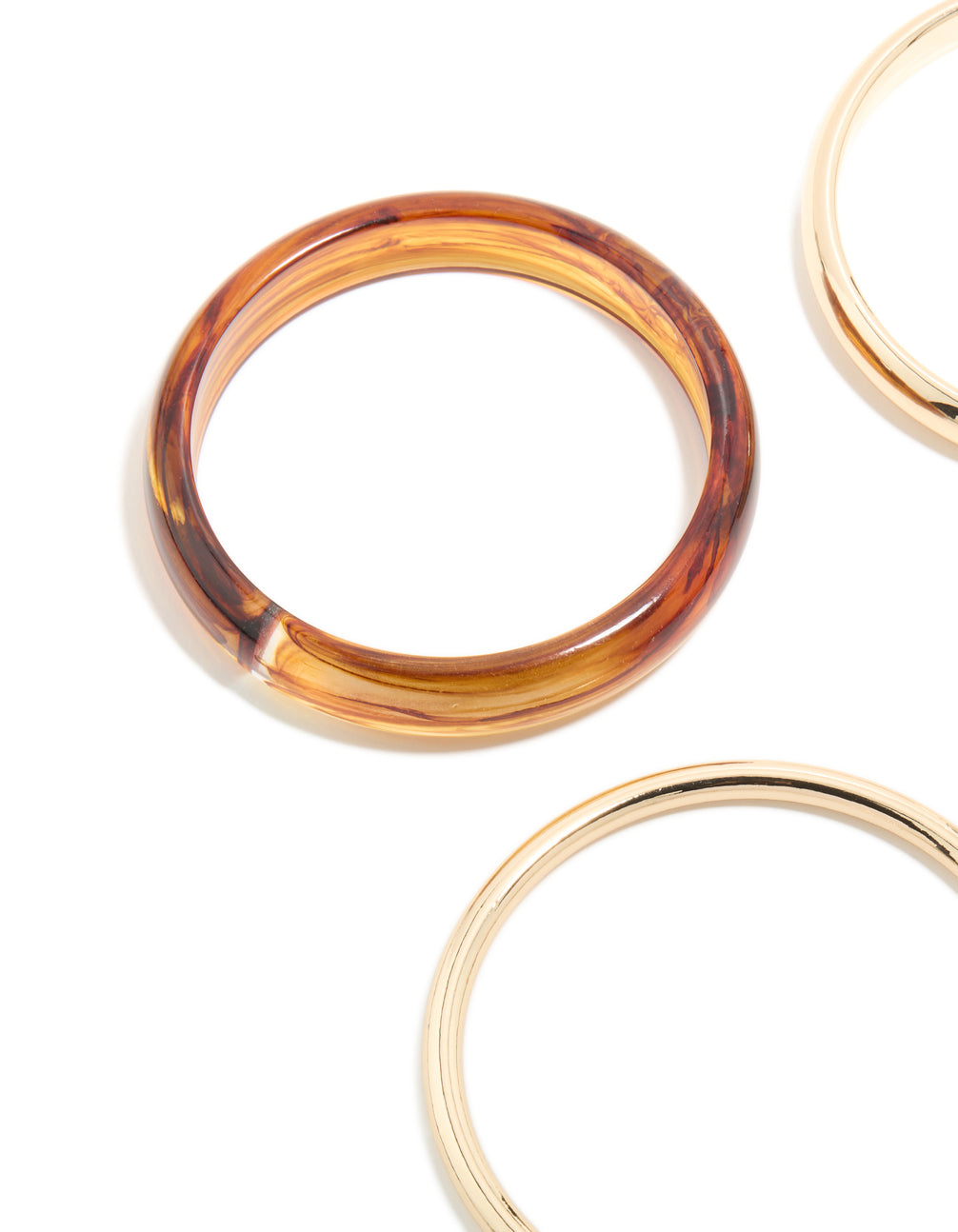 Crafted from acrylic, this gold, brown and blue 4-pack bangle set close up view