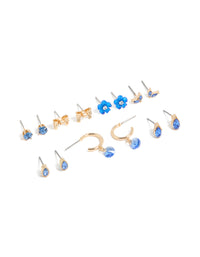 Showcasing a gold blue diamante earrings 7-pack featuring flower and bow designs with huggie and stud closures front view - link has visual effect only