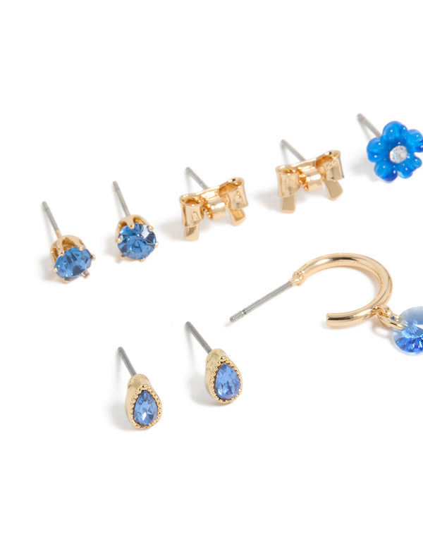 Elegantly designed gold blue diamante earrings 7-pack with flower and bow accents and stud closures close up view