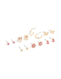 Discover this stud earrings 7-pack featuring balls, floral, butterfly, and heart designs with hot pink diamante accents in gold front view - link has visual effect only