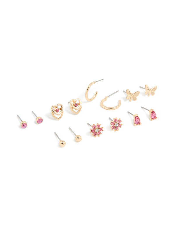 Discover this stud earrings 7-pack featuring balls, floral, butterfly, and heart designs with hot pink diamante accents in gold front view