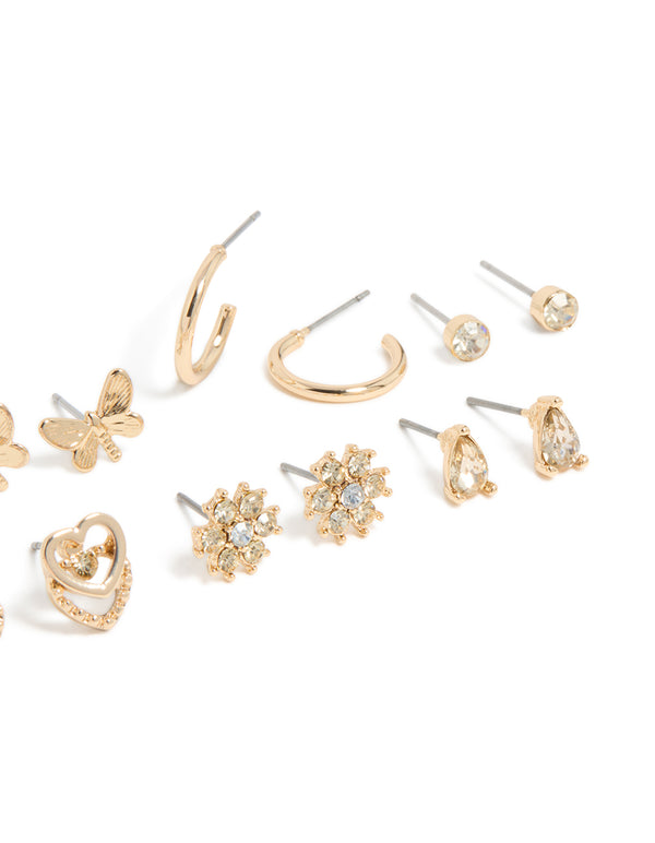 Showcasing gold diamante flower ,heart and butterfly design stud earrings 7-pack and stud closure close up view