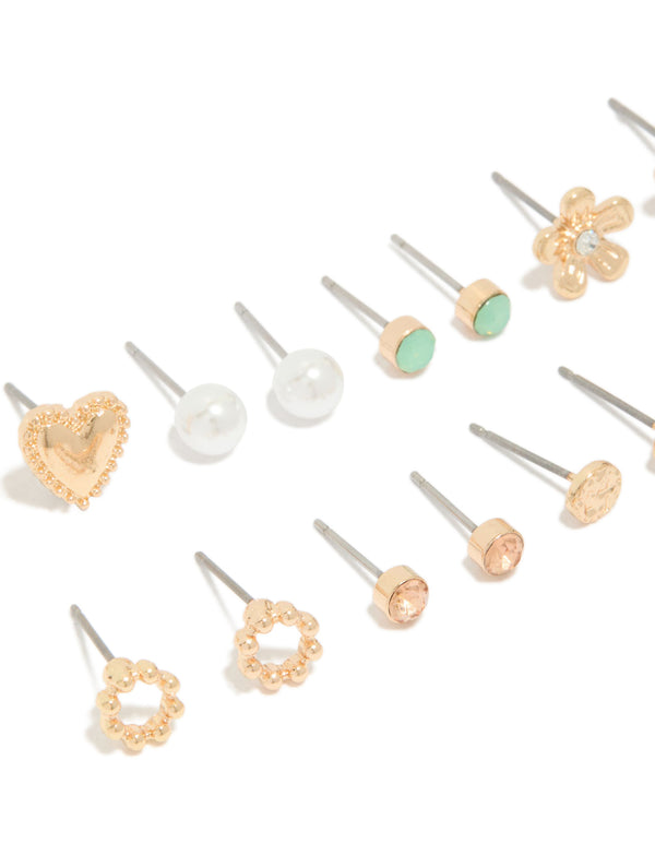 Elegant set of stud earrings in an 8-pack featuring heart, pearl, and floral designs with gold finish close up view