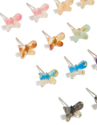 Featuring statement stud earrings in a multicoloured acrylic 8-pack with butterfly and glitter accents close up view - link has visual effect only