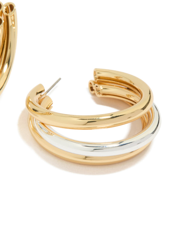 Showcasing statement large illusion hoop earrings in gold and silver plated metal post detail view