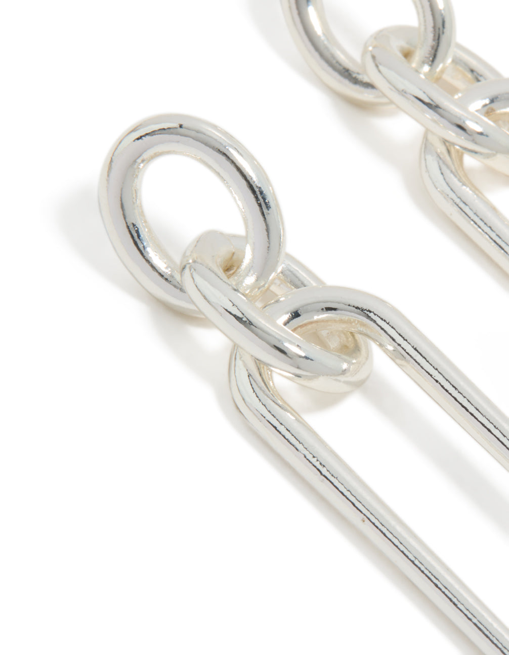 Highlighting large oval link drop earrings in statement style with silver plated finish close up view