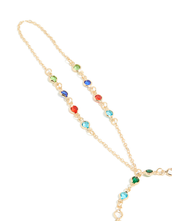 Beautifully crafted statement hand chain in multicolor diamantes featuring green, red, and blue stones close up view