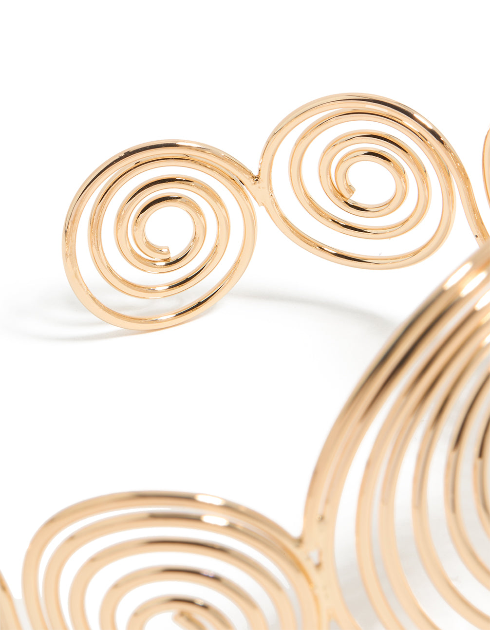 Crafted in gold, this multi swirl arm cuff bangle showcases statement styling closure detail view