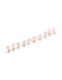 Showcasing kids clip-on earrings in a 5-pack featuring celestial, butterfly, and floral designs with glitter detailing, pink, aqua, and yellow accents, and gold tones in front view - link has visual effect only