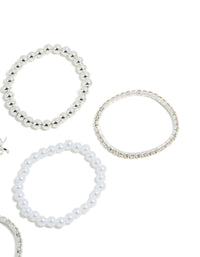 Crafted from beads these kids tennis and pearl bracelets display bow charm details in white and silver side detail view - link has visual effect only