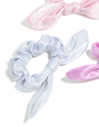 Featuring kids pastel polyester bunny ear scrunchies in a 3-pack with glitter and solid print in lavender, light blue, and light pink detail view - link has visual effect only
