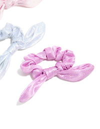 Crafted from polyester, these kids pastel bunny ear scrunchies in a 3-pack showcase glitter and solid print in lavender, light blue, and light pink side view - link has visual effect only