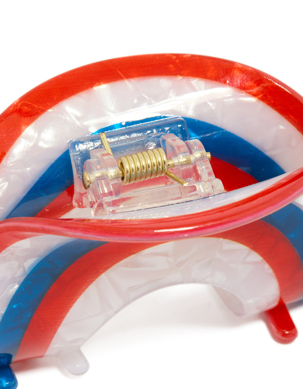 Crafted with a striped arch claw clip in red, coral, and blue detail view