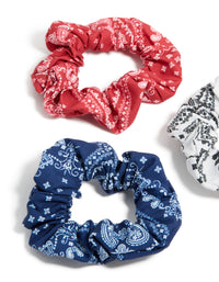 Showcasing paisley print fabric scrunchies in a 3-pack with navy, white, coral, and light sky blue side view - link has visual effect only