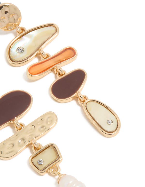 Crafted with statement mismatched design featuring charm ocean pearl and shell elements in gold post detail view