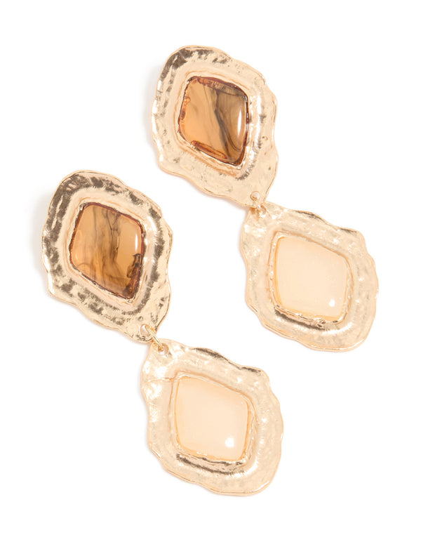 Crafted with statement style, these gold molten Aztec drop earrings feature a bold design front view