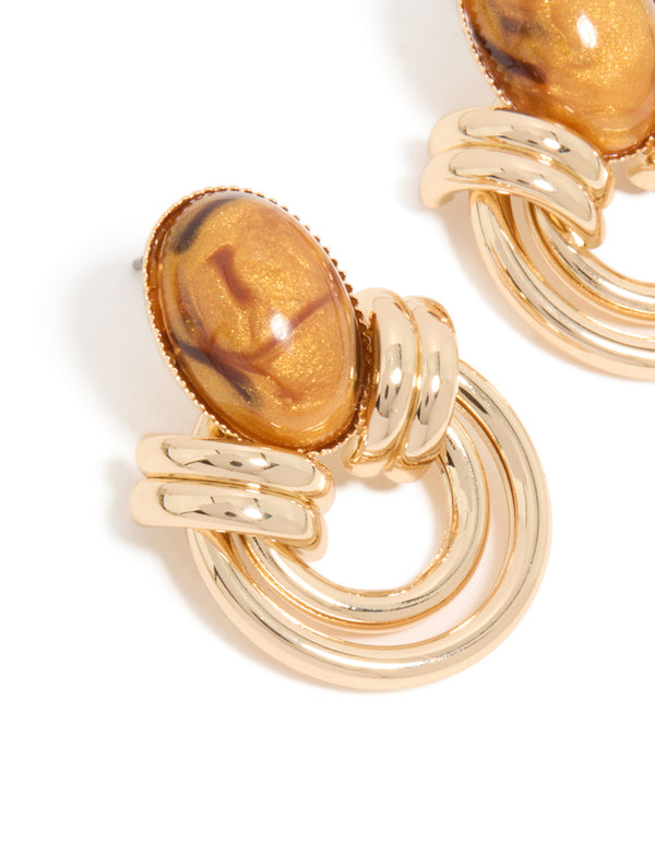 Featuring gold brown stone and double lined stud earrings close up view