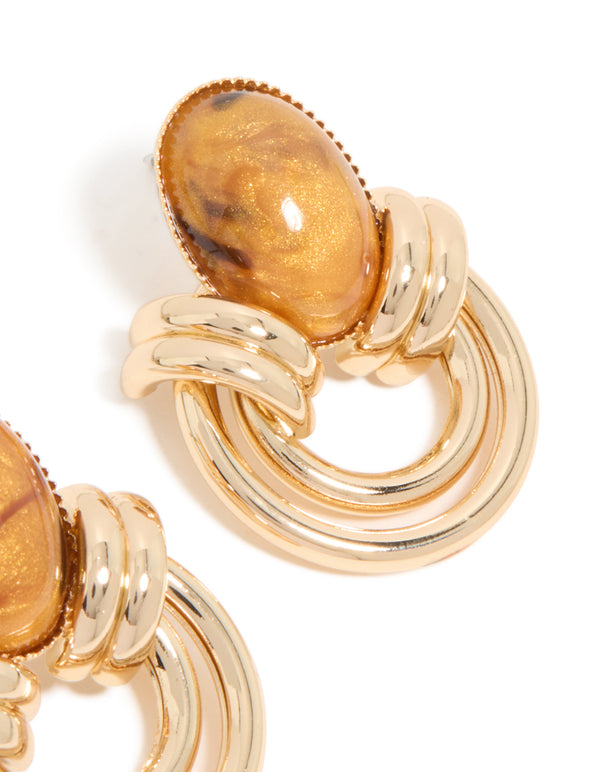 Detailed view of gold brown stone and double lined stud earrings finish