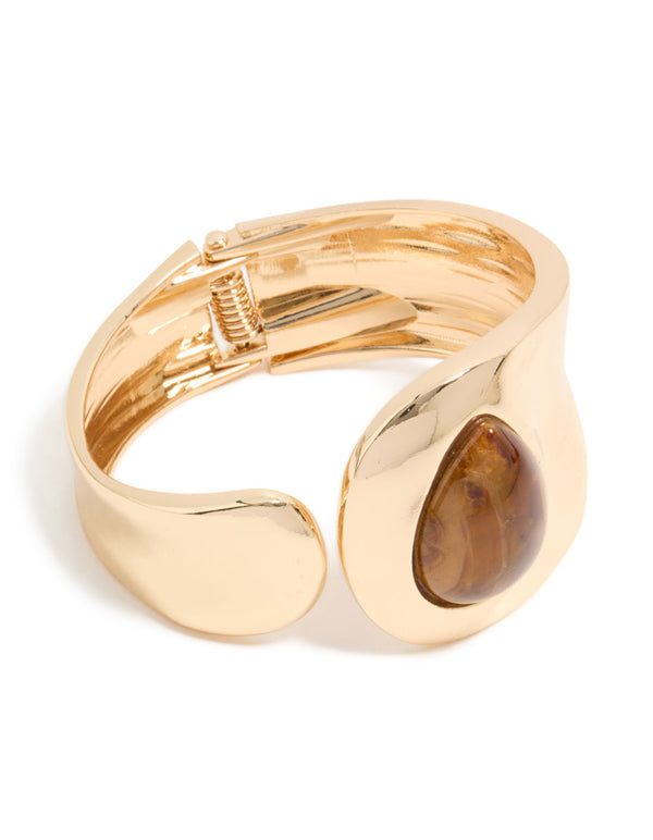 Introducing a gold teardrop brown stone wrist cuff in statement style front view
