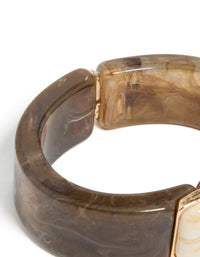 Highlighting the hinged fastening mechanism of this chunky brown and white acrylic square wrist cuff in tan, beige, and gold closure detail view - link has visual effect only