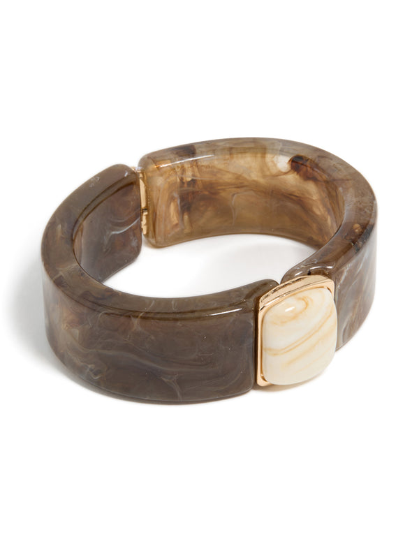 Showcasing a chunky brown and white acrylic square wrist cuff in tan, beige, and gold front view