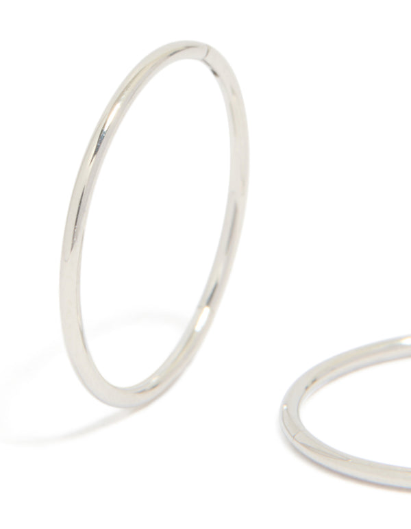 Highlighting surgical steel sleeper earrings in silver with hoop closure close up view