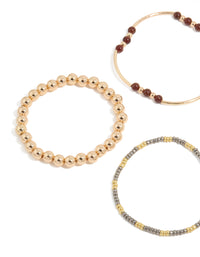 Featuring beaded stretch bracelets in blue, brown, gold, and ivory close up view - link has visual effect only