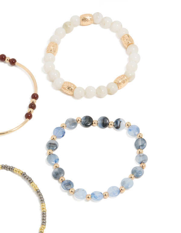 Featuring beaded stretch bracelets in blue, brown, gold, and ivory close up view
