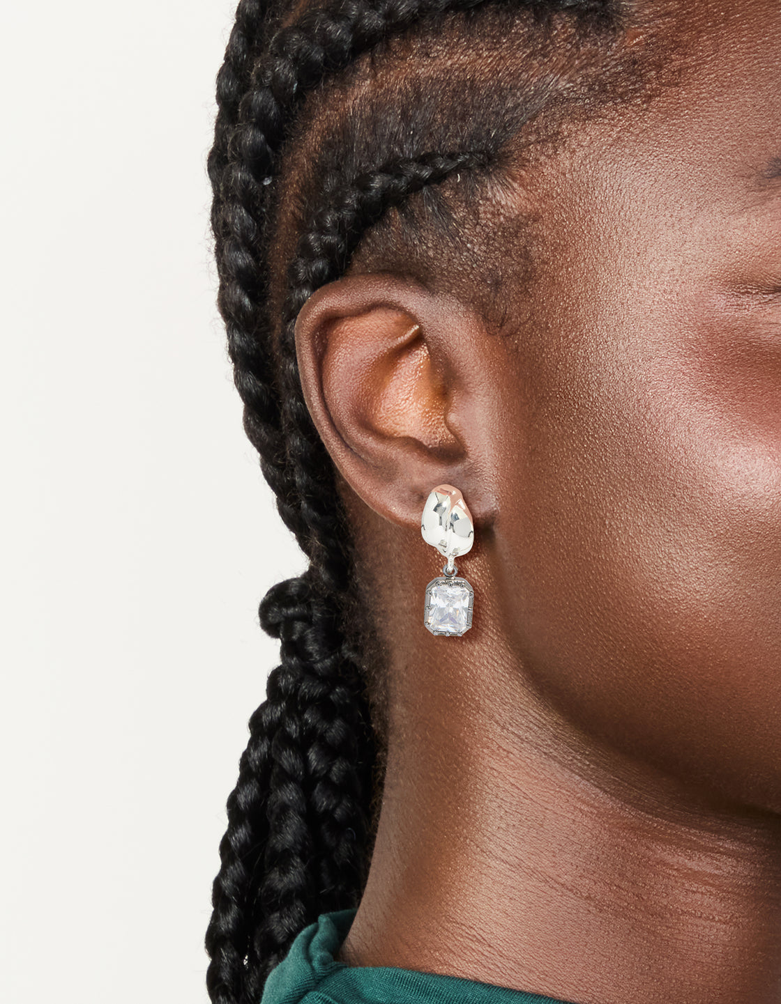 Showcasing silver and gunmetal plated cubic zirconia square drop earrings with statement style on ear view