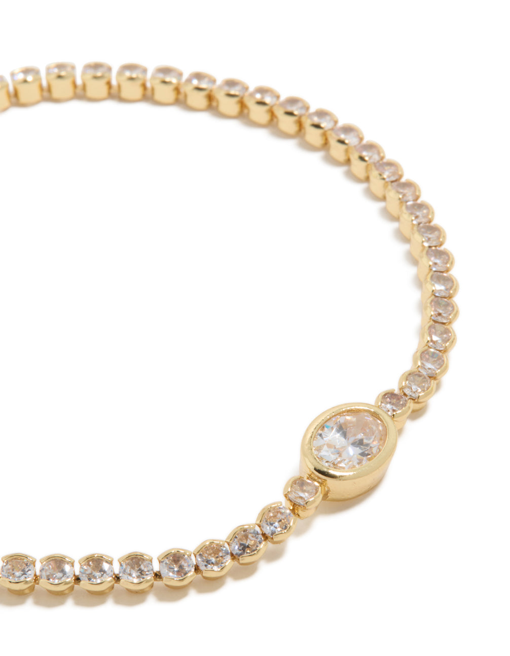 Highlighting a gold plated cubic zirconia oval tennis bracelet with clear stones close up view
